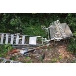 THREE SETS OF ALUMINIUM STEPS largest being 2m high, a quantity of garden tools, a wheelbarrow and a