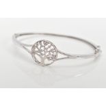 A SILVER 'TREE OF LIFE' HINGED BANGLE, decorative openwork tree of life emblem set with colourless