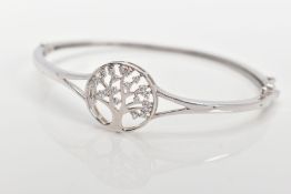 A SILVER 'TREE OF LIFE' HINGED BANGLE, decorative openwork tree of life emblem set with colourless