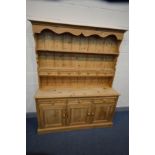 A PINE DRESSER with seven assorted drawers and triple cupboard doors, width 153cm x depth 43cm x
