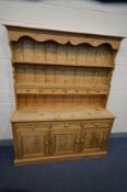 A PINE DRESSER with seven assorted drawers and triple cupboard doors, width 153cm x depth 43cm x