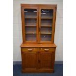 AN EARLY 20TH CENTURY OAK GLAZED TWO DOOR BOOKCASE, two drawers above two fielded panel doors, width