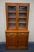 AN EARLY 20TH CENTURY OAK GLAZED TWO DOOR BOOKCASE, two drawers above two fielded panel doors, width