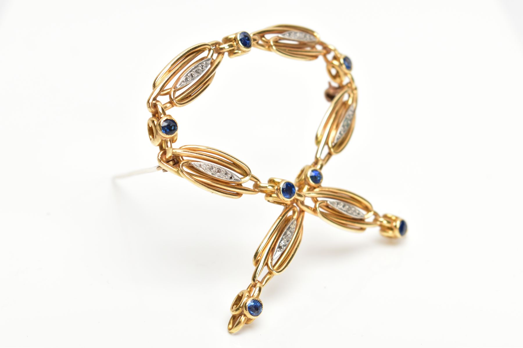 A YELLOW METAL SAPPHIRE AND DIAMOND SET BROOCH, openwork cross over design, set with circular cut - Image 2 of 3