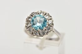 A WHITE METAL GEM SET CLUSTER RING, of a flower shape, centring on a circular cut blue zircon within