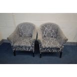 A PAIR OF FLORAL UPHOLSTERED TUB CHAIRS (faded and worn armrests)