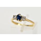 AN 18CT GOLD SAPPHIRE AND DIAMOND THREE STONE RING, centring on a claw set, oval cut blue