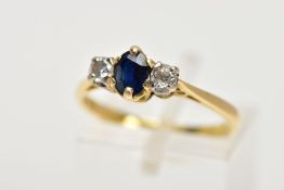 AN 18CT GOLD SAPPHIRE AND DIAMOND THREE STONE RING, centring on a claw set, oval cut blue