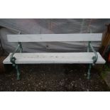 A HEAVY CAST IRON GARDEN BENCH, the ends in the form branches, later painted, length 180cm