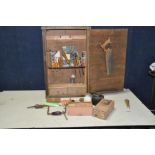 A VINTAGE WOODEN TOOL CUPBOARD containing hand tools including a boxed BB Planes wooden block