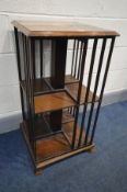 A LATE 20TH CENTURY MAHOGANY AND INLAID REVOLVING BOOKCASE, with two tiers on small bracket feet,