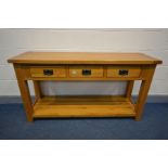 A SOLID OAK SIDE TABLE with three drawers, block legs united by an undershelf, width 150cm x depth