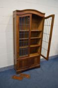 AN EARLY 20TH CENTURY OAK DOUBLE DOOR BOOKCASE, the lead glazed doors enclosing three adjustable