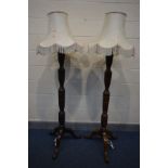 A PAIR OF EDWARDIAN MAHOGANY CONVERTED STANDARD LAMPS, on tripod legs, with fabric shades, height