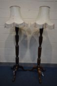 A PAIR OF EDWARDIAN MAHOGANY CONVERTED STANDARD LAMPS, on tripod legs, with fabric shades, height