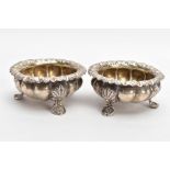 TWO SILVER BONBON DISHES, each with an embossed bowl, worn gilt interior, flower detailed rims, each
