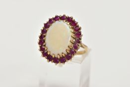 A YELLOW METAL OPAL AND RUBY CLUSTER RING, large cluster centring on an oval cut opal cabochon,