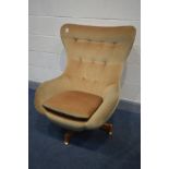 A GREAVES AND THOMAS SWIVEL EGG CHAIR, gold upholstered on a teak base (this chair does not comply