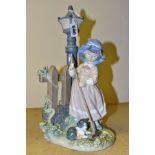 A LLADRO FIGURE GROUP FALL CLEAN UP, model no 5286, depicting a girl raking up leaves, designed by