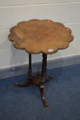 AN LATE VICTORIAN WALNUT TRIPOD TABLE, with a carved wavy top, triple supports and splayed legs,