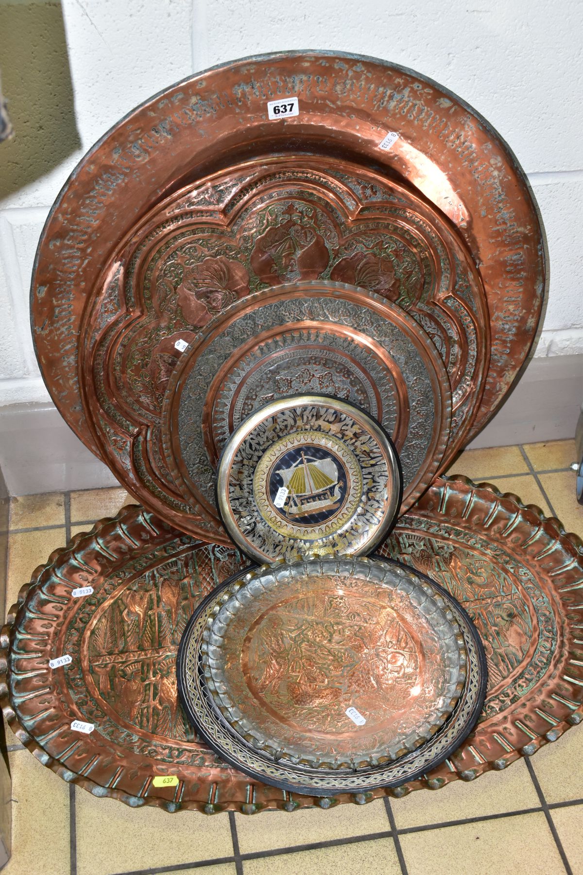 A COLLECTION OF SEVEN INDIAN/MIDDLE EASTERN METAL PLATTERS, CHARGERS AND TRAYS, all either