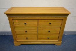 A SOLID OAK FRENCH STYLE SIDEBOARD/CHEST OF SIX DRAWERS, width 129cm x depth 46cm x height 90cm