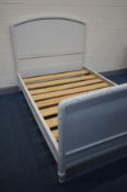 A 4FT6 BEDSTEAD, later painted, on bulbous legs and metal casters, with slats and side supports,