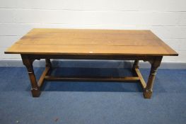 A REPRODUCTION OAK REFECTORY TABLE, in the 18th century style, the plank top on turned and block