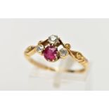 A YELLOW METAL RUBY AND DIAMOND DRESS RING, designed with a cushion cut ruby, flanked with old cut