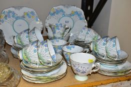 A ROYAL STAFFORD BONE CHINA TEA SET, pattern no 7713, a printed and tinted floral design, comprising