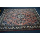 A WOOLLEN KASHAN RUG, red and cream ground, with a multi strap border, 316cm x 213cm