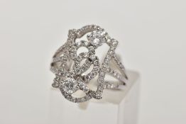 A MODERN DIAMOND FANCY RING, designed as an open rectangular head of scroll design with two larger