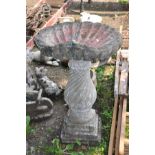 A LARGE COMPOSITE BIRDBATH with shell shaped top 52cm in diameter on a twisted baluster base with