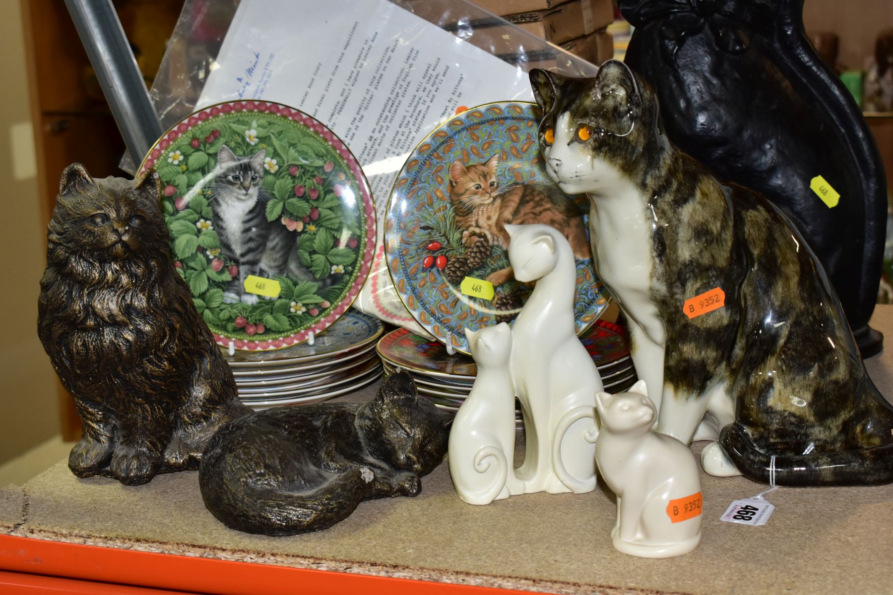 CAT THEMED SCULPTURES AND COLLECTORS PLATES, comprising a Mike Hinton pottery seated cat, height