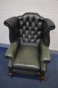 A GREEN LEATHER BUTTON BACK WINGBACK CHAIR on cabriole legs, width 90cm x depth 87cm x height