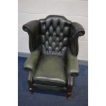 A GREEN LEATHER BUTTON BACK WINGBACK CHAIR on cabriole legs, width 90cm x depth 87cm x height