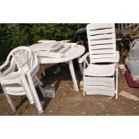 A WHITE PLASTIC GARDEN TABLE 140cm long , three chairs and a pair of loungers (6)