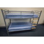 A METAL FRAMED BUNK BED with two mattresses