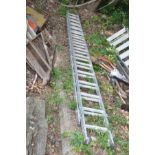 A SET OF ALUMINIUM DOUBLE EXTENSION LADDERS one section is 4m long with 15 rungs the other is 4.
