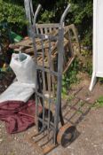 A VINTAGE METAL SACK TRUCK with cast iron wheels