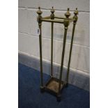 A BRASS UMBRELLA/STICK STAND with a cast iron base, 18cm squared x height 64cm