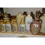 A QUANTITY OF STONEWARE BOTTLES, FLAGONS, JARS, etc, hot water bottles, salt pot with wooden