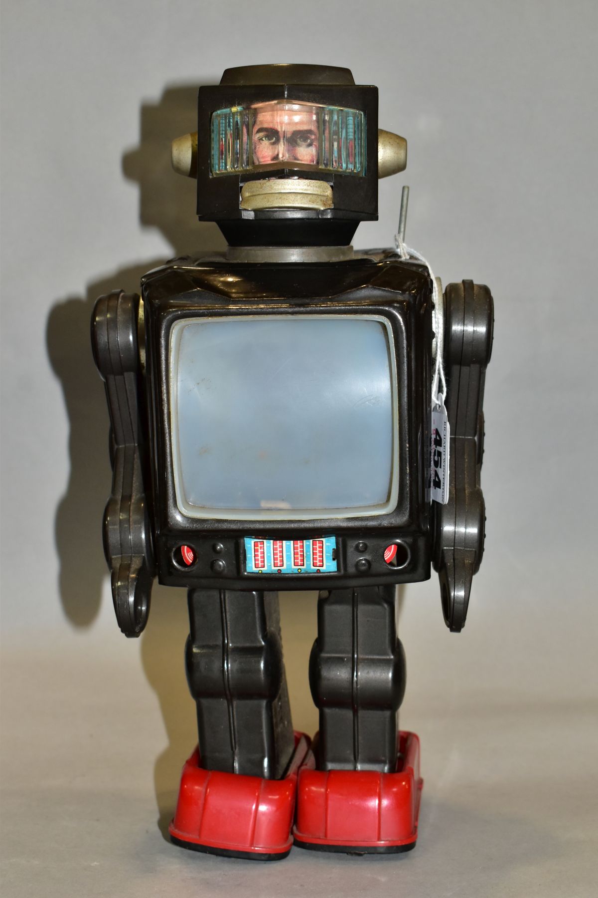 A TINPLATE AND PLASTIC BATTERY OPERATED TV ROBOT, marked 'Made in Japan' but no makers marking,