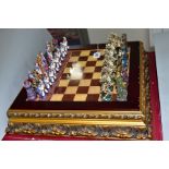 A BOXED MODERN CHESS SET, resin figures, modelled as fantasy figures, board mounted on a raised