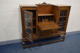 AN EARLY 20TH CENTURY OAK SIDE BY SIDE BUREAU/BOOKCASE, a raised back with centre pediment above a