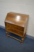 AN EARLY 20TH CENTURY WALNUT BUREAU, fall front door enclosing a fitted interior, above two