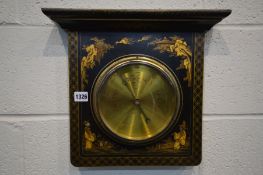 AN EBONISED ORIENTAL ANEROID BAROMETER, with chinoiserie detail, 35cm x 39cm