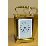 AN EARLY 20TH CENTURY FRENCH BRASS CARRIAGE CLOCK, the rectangular case with small oval panel to the