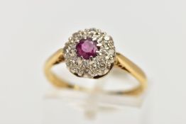 AN 18CT GOLD RUBY AND DIAMOND CLUSTER RING, centring on a circular cut ruby, within a single cut