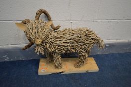 A TWIG SCULPTURE OF A RAM, on a wooden plinth, length 66cm